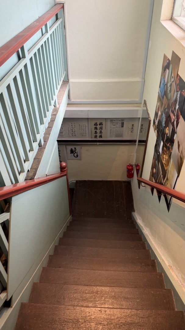 Walk through the association hallway and up the wooden stairs.